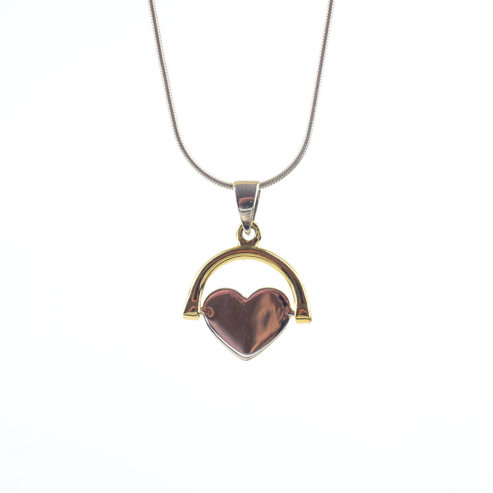 A Sterling Silver Spinning Heart by Engravable Jewellery featuring an adjustable chain and a pendant. The heart-shaped pendant, made of a polished brown material and framed in gold, is suspended from a small gold arch. This simplistic yet elegant design allows for optional engraving, adding a personal touch to the piece.