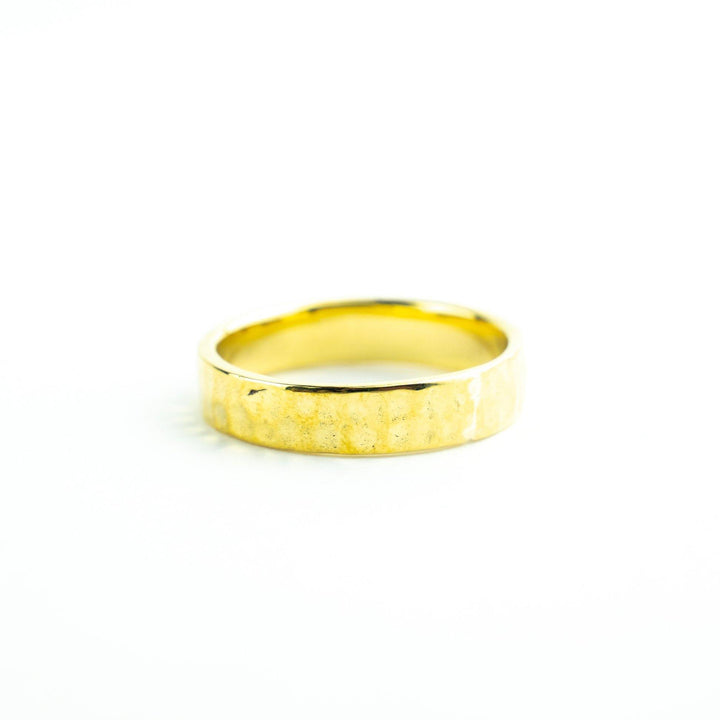 An Engravable Jewellery Engravable Simple Hammered Gold Vermeil Band with a matte, slightly textured finish is showcased against a clean white background. The band has a simple, unadorned design and a gentle, rounded shape.