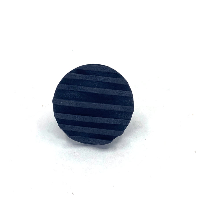 A small, round, black 3D printed Vibe Wave Circle Fascia Ring by Elsiem with evenly spaced parallel grooves on its surface, dyed in matt black and placed against a plain white background.