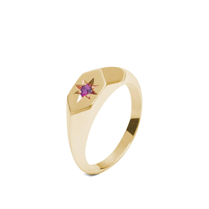 Introducing the Cosmic Boulevard Starlight Pink Tourmaline Birthstone 9ct Gold Signet Ring: a polished gold band with a radiant pink tourmaline gemstone set at its center within a star-shaped engraving on a hexagonal bezel. The design is sleek and modern, emphasizing simplicity and elegance.