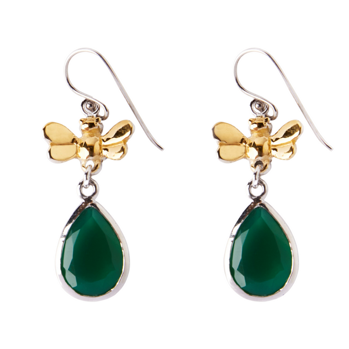 Part of our wildlife collection, the Wildlife Bee Drops in various gemstones by Gallardo & Blaine Designs feature golden bee designs at the top. Below each bee is a green, teardrop-shaped gemstone encased in a silver setting. The earrings have hook-style fastenings. The combination of metallic and gemstone elements creates an elegant look.