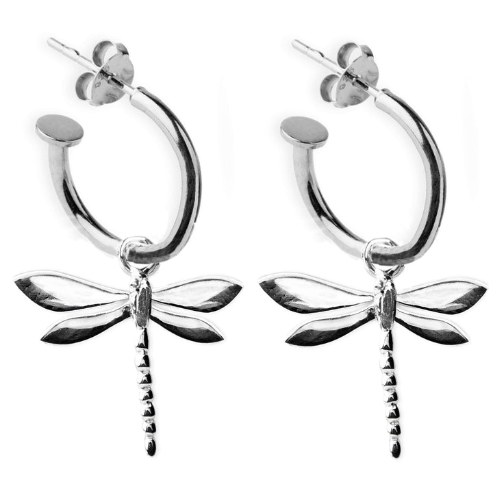 A pair of Wildlife Dragonfly Huggies by Gallardo & Blaine Designs. The dragonflies feature intricately detailed wings and a segmented body, hanging from the bottom center of each hoop. These elegant earrings have stud backs for secure fastening.