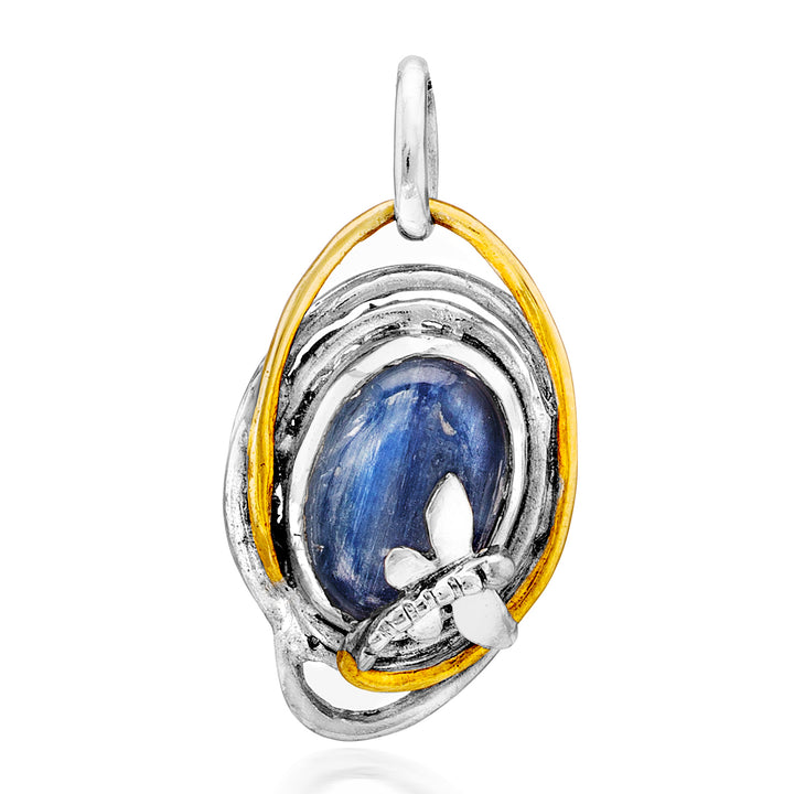 A Lagoon Pendant Small in various gemstones by Gallardo & Blaine Designs featuring a blue oval gemstone encased in a silver and gold twisted metal design. The intricate design includes a small silver butterfly detail at the bottom right of the stone. This exquisite pendant has a loop at the top for attaching to a necklace.