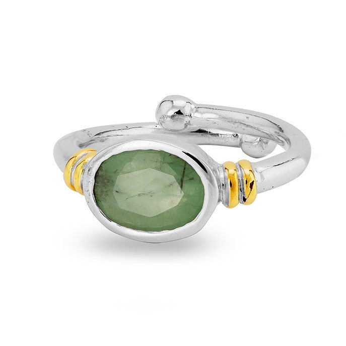 The Senna Ring in various gemstones by Gallardo & Blaine Designs is a silver adjustable ring featuring an oval green gemstone at the center. The ring has a polished finish with two small bands of gold on either side of the gemstone, adding a touch of contrast and elegance.