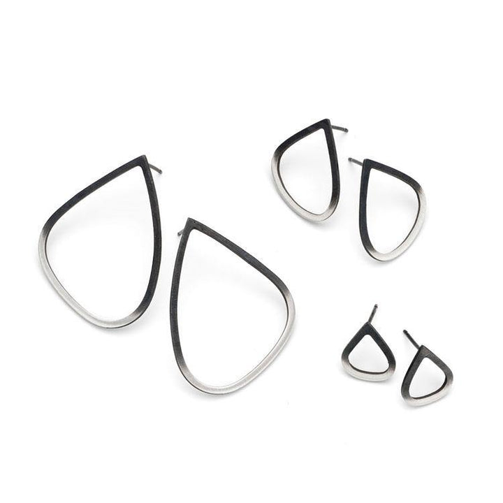 The image shows three pairs of Two Tone Silver Wing Stud Earrings by Leoma Drew in varying sizes. Crafted from oxidised sterling silver, the earrings feature a gradient finish transitioning from dark at the outer edges to light in the inner areas.